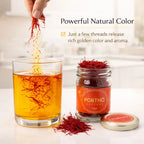 Saffron being added to a glass of liquid with a jar of saffron and a small container labeled 'Porthó' on a light background.